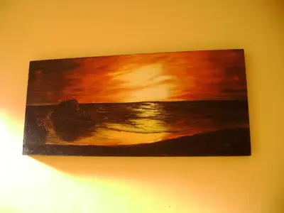 a painting of the ocean on a wall at Aandvari Sunset Court in Cape Town