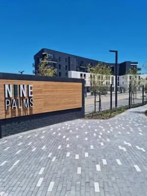 a sign that says nine palms on a brick sidewalk at Nine Palms - Century City Luxury Apartment in Cape Town