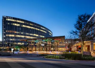 a large glass building with a street in front of it at Nine Palms - Century City Luxury Apartment in Cape Town