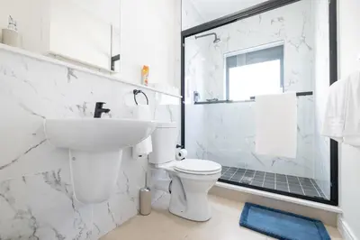 a white bathroom with a sink and a toilet at #AlimamaSpaces Manson's Fynbos Villa in Cape Town