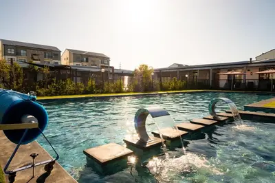 a swimming pool with two chairs in the water at #AlimamaSpaces Manson's Fynbos Villa in Cape Town