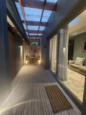 a living room with a ceiling with a skylight at Overflowing Life - Accommodation near Paarl Gim in Paarl