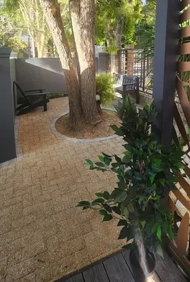 a patio with a tree and a vase with a plant at Overflowing Life - Accommodation near Paarl Gim in Paarl