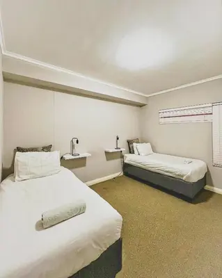 a hotel room with two beds and a window at Spacious 2 bedroom Apt near Canal Walk in Cape Town