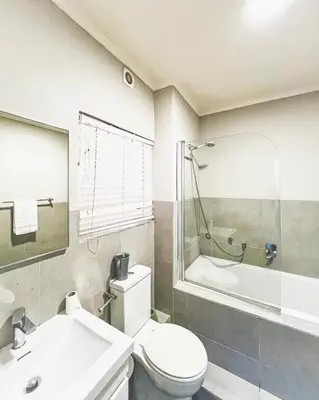 a bathroom with a toilet and a sink and a tub at Spacious 2 bedroom Apt near Canal Walk in Cape Town