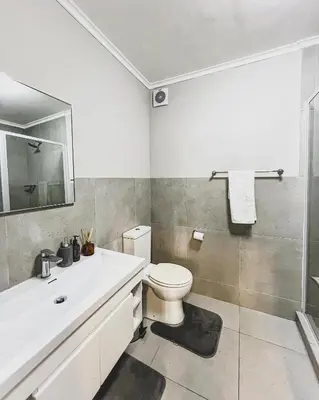 a bathroom with a toilet and a sink and a shower at Spacious 2 bedroom Apt near Canal Walk in Cape Town