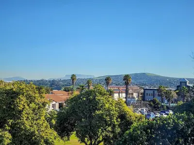 a view of a town with palm trees and cars at The Nest at Durbanville in Cape Town