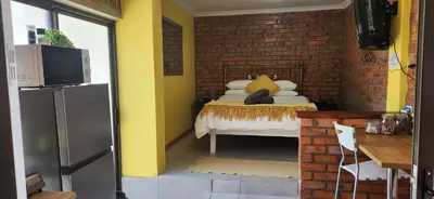 a room with a bed and a brick wall at LyonsDen 1 in Worcester