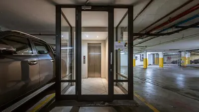 an open door in a parking garage with a car at The Mustard Seed in Stellenbosch