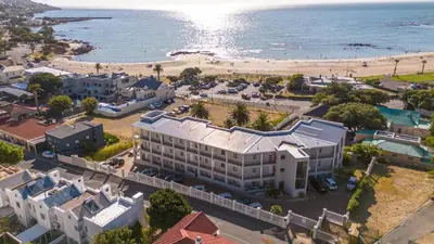 an aerial view of a building and the beach at Ocean & Mountain View Escape, 100m Walk to beach - Gordon's Bay in Gordonʼs Bay