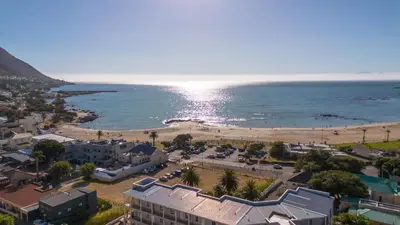 an aerial view of a beach next to the ocean at Ocean & Mountain View Escape, 100m Walk to beach - Gordon's Bay in Gordonʼs Bay