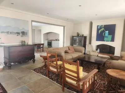 a living room with a couch and a piano at Stellenbosch family villa in Stellenbosch