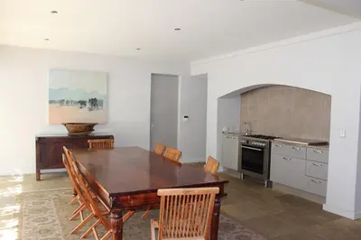 a kitchen with a wooden table and a dining room at Stellenbosch family villa in Stellenbosch