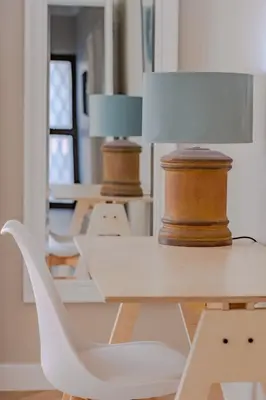 a row of white tables with lamps on them at Belle Apartment in Hermanus