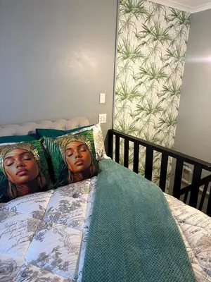 a bed with two heads on the pillows at TLP Haven in Cape Town