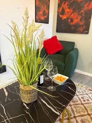 a living room with a table with wine glasses and a couch at TLP Haven in Cape Town