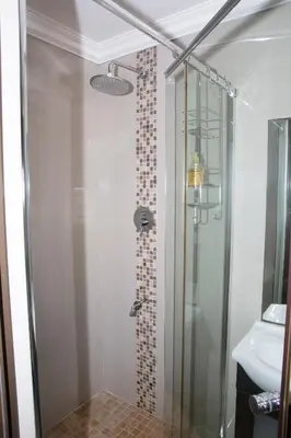 a bathroom with a glass shower with a sink at 20 On Percy Unit 3 in Parkwood