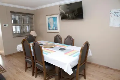 a dining room with a table and chairs at 20 On Percy Unit 3 in Parkwood