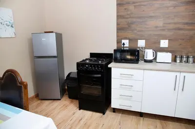 a kitchen with a black stove and a refrigerator at 20 On Percy Unit 3 in Parkwood