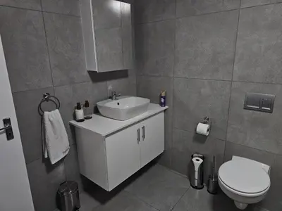a bathroom with a white sink and a toilet at Evert's Home in Bellville