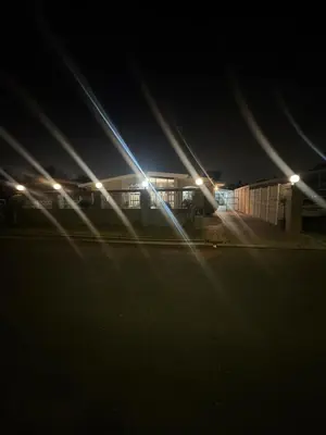 a train station at night with lights on the tracks at Ewanges holiday home in Windsor Park