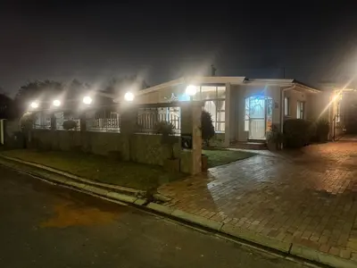 a house with lights on the side of it at night at Ewanges holiday home in Windsor Park