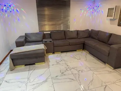 a living room with a couch and a marble floor at Ewanges holiday home in Windsor Park