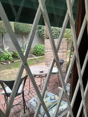 a view of a patio with a table and chairs at Rusticana A in Cape Town