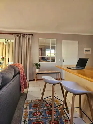 a living room with a couch and a table with a laptop at Max 7 in Helderberg