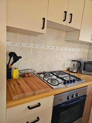 a kitchen with a stove and a counter top at Max 7 in Helderberg
