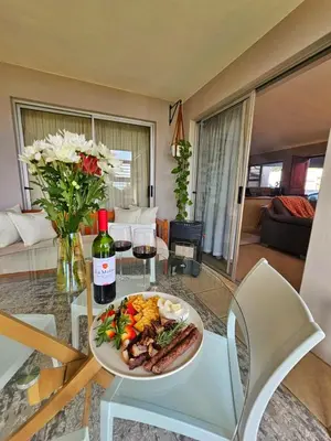 a plate of food on a glass table in a living room at Max 7 in Helderberg