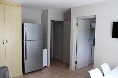 a kitchen with a refrigerator in a room at Grace Haven Self Catering in Hermanus