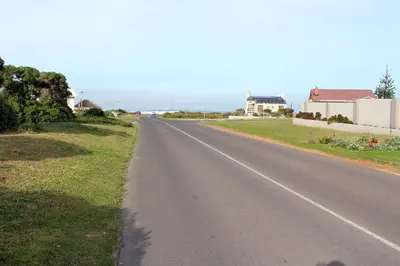 an empty road with houses in the distance at Grace Haven Self Catering in Hermanus