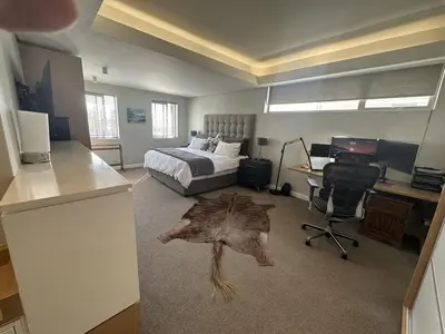 a bedroom with a bed and a desk and a desk at Sunset Links Golf Estate home, walk to Beach in Cape Town
