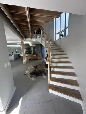 a staircase in a house with a living room at Sunset Links Golf Estate home, walk to Beach in Cape Town