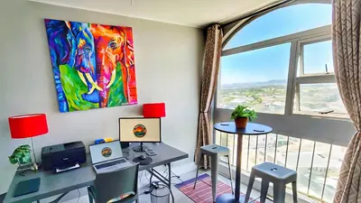 a room with a desk and a large window at Views Views and more Views Stunning 2 bed Apartment in Strand