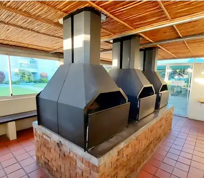 an outdoor kitchen with a stove top oven at Views Views and more Views Stunning 2 bed Apartment in Strand