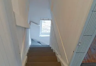 a staircase in a house with a window at Studio at Providence in Hermanus