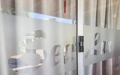 a window with the word cafe written on it at Sealax Cottage Fleurpark in Gordonʼs Bay