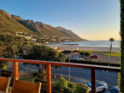 a view of the beach from a balcony at Flat 9, Beachfront 2 Bedroom with Sea View for 4 in Gordonʼs Bay