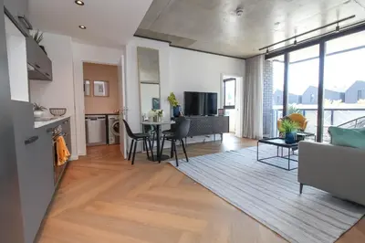 a living room with a couch and a table at The Bridgewater Collection 409-Luxury 2 bed Modern Apartment at Century City in Cape Town