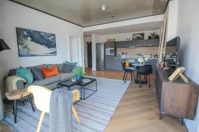 a living room with a couch and a table at The Bridgewater Collection 409-Luxury 2 bed Modern Apartment at Century City in Cape Town