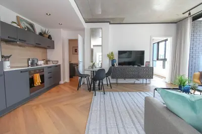 a living room with a kitchen and a dining room at The Bridgewater Collection 409-Luxury 2 bed Modern Apartment at Century City in Cape Town