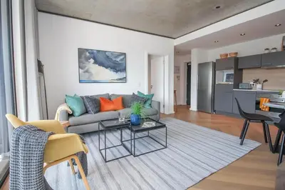 a living room with a couch and a table at The Bridgewater Collection 409-Luxury 2 bed Modern Apartment at Century City in Cape Town