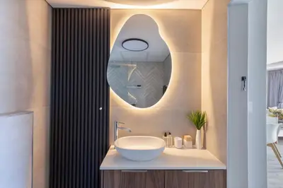 a bathroom with a sink and a mirror at Horizon Bay 903 Fresh Beachfront Hideaway in Cape Town