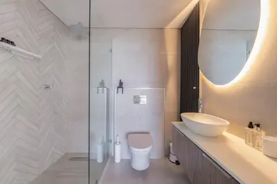 a bathroom with a toilet and a sink and a shower at Horizon Bay 903 Fresh Beachfront Hideaway in Cape Town