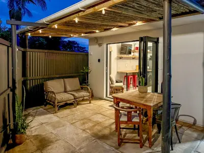 a patio with a table and chairs and a couch at Dublin - 2 Bedroom Apartment in Blomtuin