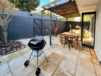 a barbecue grill on a patio with a table at Dublin - 2 Bedroom Apartment in Blomtuin