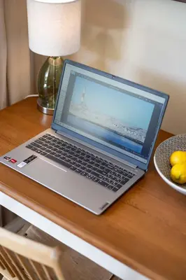 a laptop computer sitting on top of a wooden table at The Pearl in the Winelands in Paarl