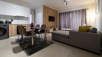 a living room with a couch and a table at AlimamaSpaces The Fynbos Chelsea in Cape Town